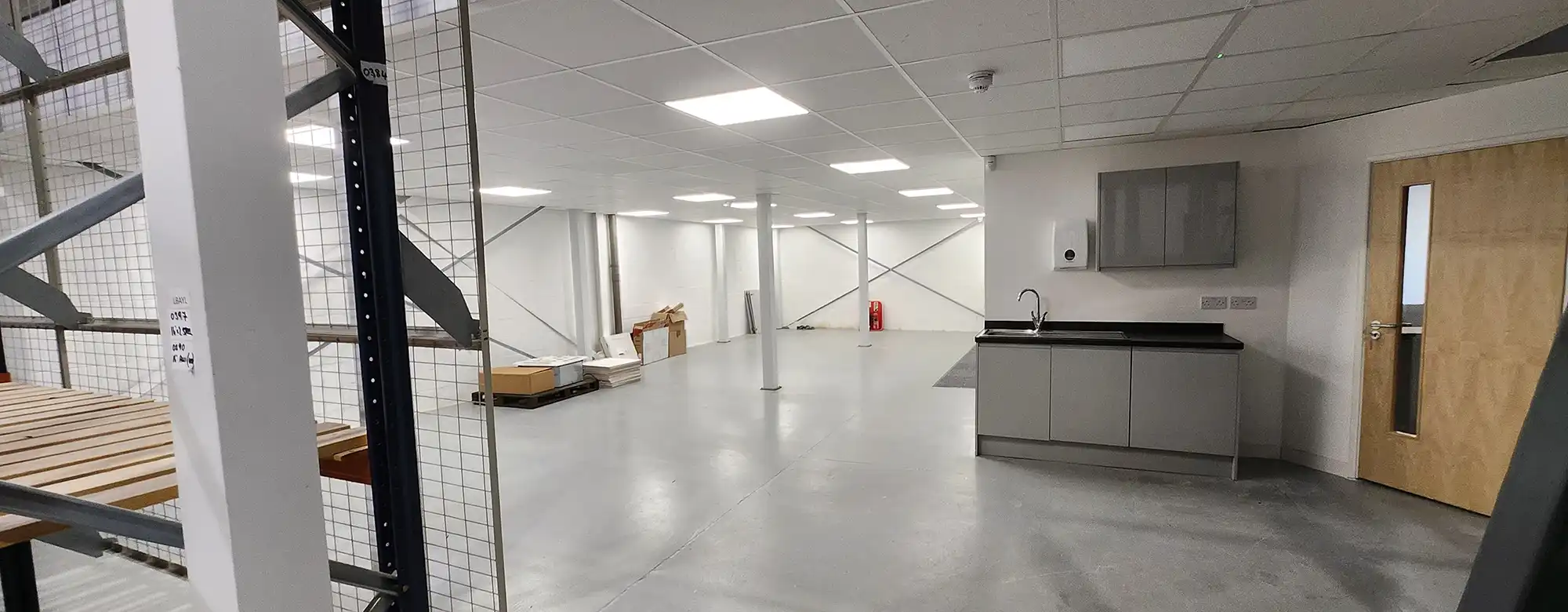 An empty room with a wooden table and stairs.
