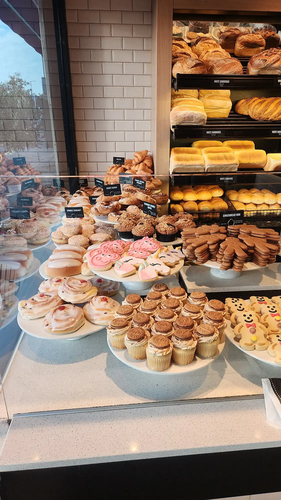 A display case filled with lots of different types of doughnuts.